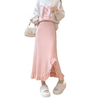 Woman wearing the Ruffle Slit Knit Midi Skirt in pink with a white sweatshirt
